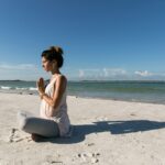 일상 속에서 만나는 대체요법, 건강한 삶을 위한 소소한 변화 woman praying and sitting on sand seashore during day